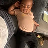 Zehlani joined the competition — help win amazing prizes! baby, sleeping, child, couch, pillow, clothing, black_pants, peach_shirt, relaxed, indoors, person, infant, resting, home, furniture, footwear, can, floor, casual, portrait