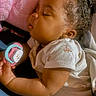 Zehlani joined the competition — help win amazing prizes! baby, sleeping, pacifier, pink_pillow, curly_hair, white_clothing, infant, peaceful, close_up, soft_light, indoor, child, toddler, skin, hand, portrait, cute, resting, cozy, comfort
