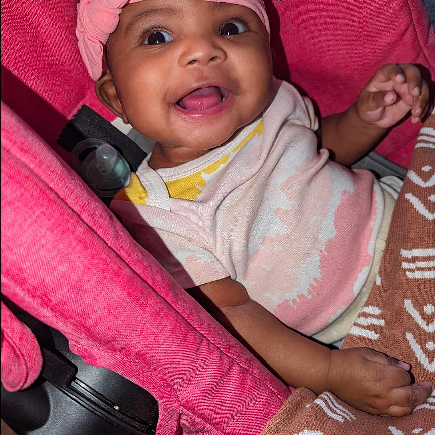 Amarrah joined the competition — help win amazing prizes! baby, baseballcap, bodypart, bonnet, cap, clothing, cushion, face, finger, hand, happy, hat, head, homedecor, newborn, person, photography, portrait, purple, smile