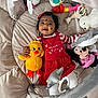baby, child, plush_toy, stuffed_animal, giraffe_toy, polar_bear_toy, minnie_mouse_toy, yellow_chick_toy, play_mat, red_dress, white_tights, smiling, happy, indoors, cute, infant, headband, toy_ring, soft_toys, childhood