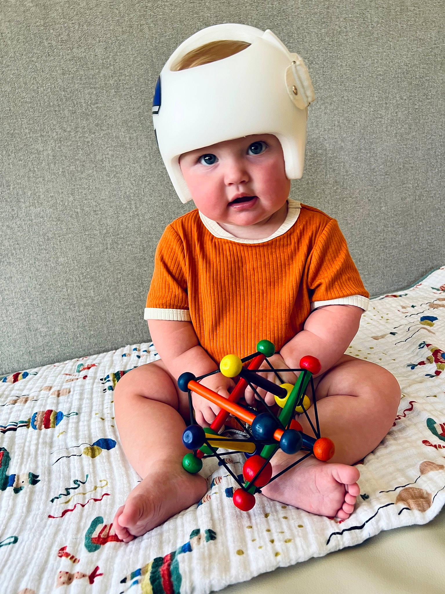 Dru is registered to the contest to win money with this photo: baby, baby_products, baby_toddler_clothing, cap, child, collar, comfort, costume_hat, dress, face, fashion_accessory, fun, happy, head, headwear, linens, pattern, person, sitting, sleeve