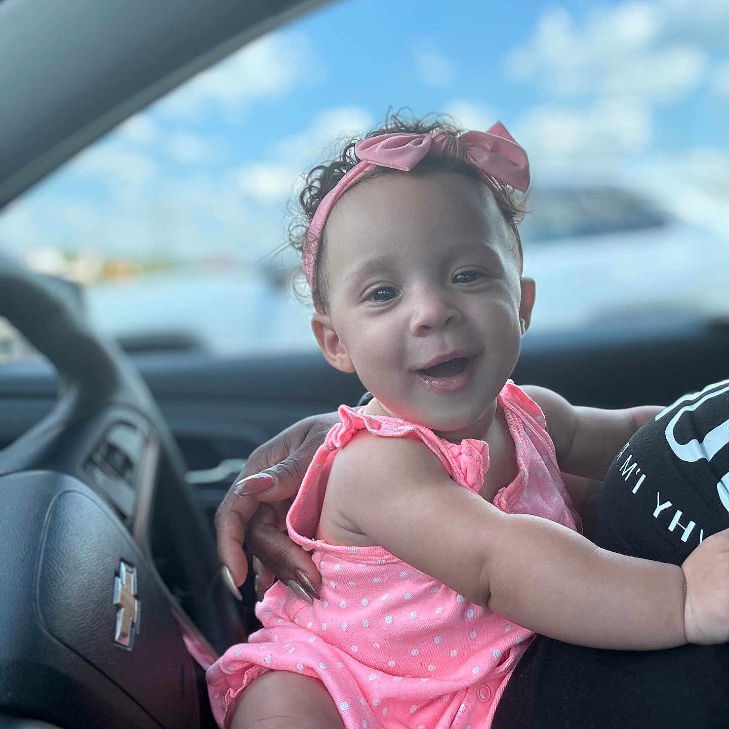 Skylar is registered to the contest to win money with this photo: accessories, baby, car, clothing, dress, face, happy, head, machine, person, photography, portrait, sedan, sitting, smile, steeringwheel, sunglasses, t_shirt, transportation, vehicle