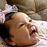 Kylieannah is registered to the contest to win money with this photo: adorable, baby, child, close_up, couch, cushion, eyes, face, floral_fabric, happy, headband, indoor, infant, lace_bow, open_mouth, pink_clothing, portrait, sitting, smiling, soft_lighting