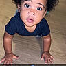 toddler, child, curly_hair, crawling, wooden_floor, indoor, looking_up, cute, blue_heart_emoji, snapchat_overlay, person, skin, hand, face, eyes, young_child, casual_clothing, flooring, baby, expression