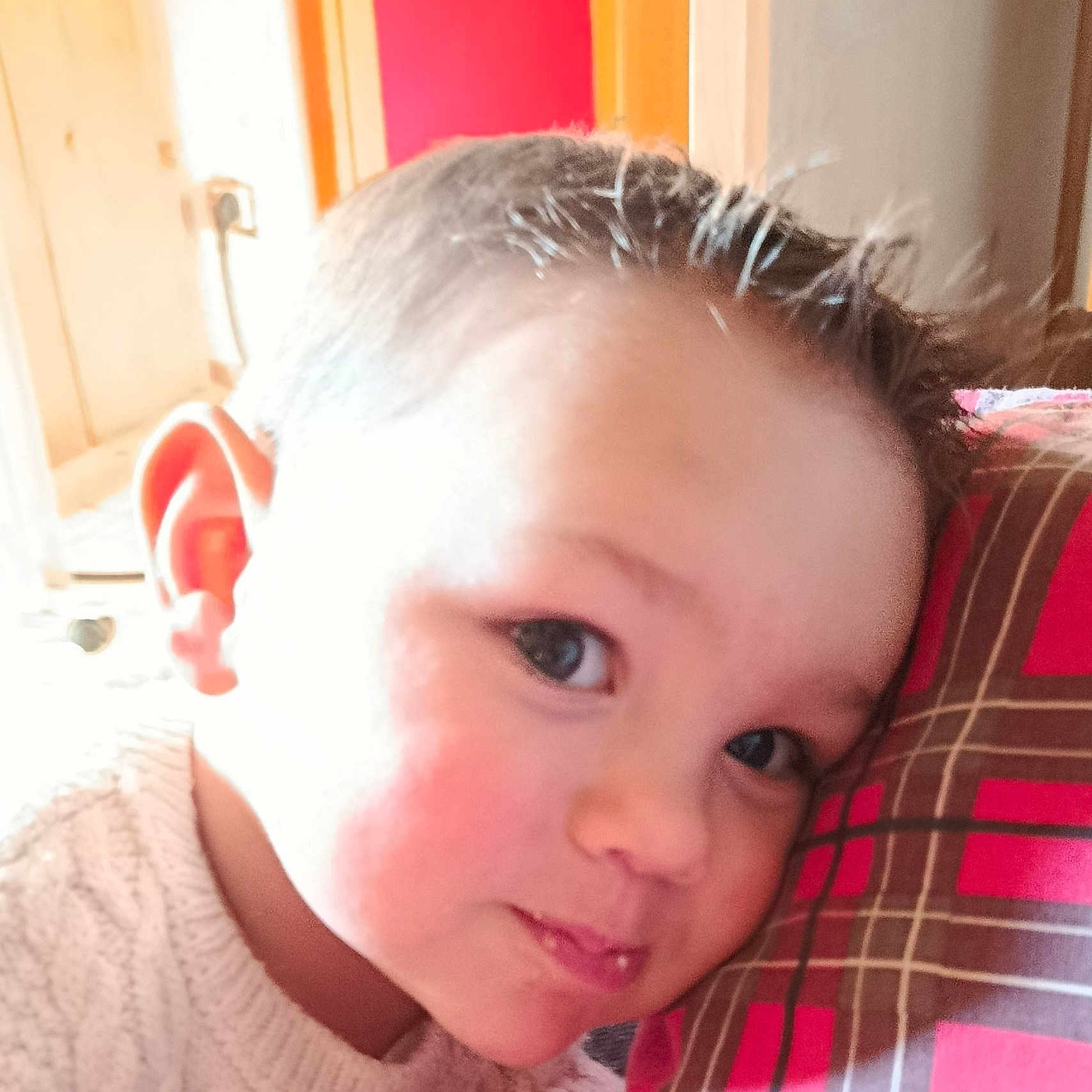 Marius participe au concours pour gagner de l'argent avec cette photo : cheek, child, closeup, cozy, cute, expression, face, hair, head, indoor, light, pattern, person, pillow, portrait, resting, smile, sweater, warm, young