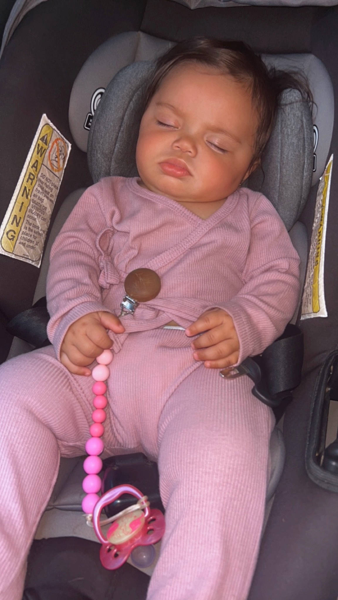 Hennesea is registered to the contest to win money with this photo: arm, baby, baby_carriage, baby_toddler_clothing, beauty, car_seat, cheek, child, comfort, finger, hand, lap, mouth, nail, person, pink, seat_belt, skin, thigh, thumb