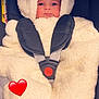 baby, child, car_seat, safety_harness, fluffy_clothing, hood, ears, cute, infant, warm, seatbelt, car_interior, red_button, heart_emoji, portrait, face, wide_eyes, soft_texture, cozy, wrapped