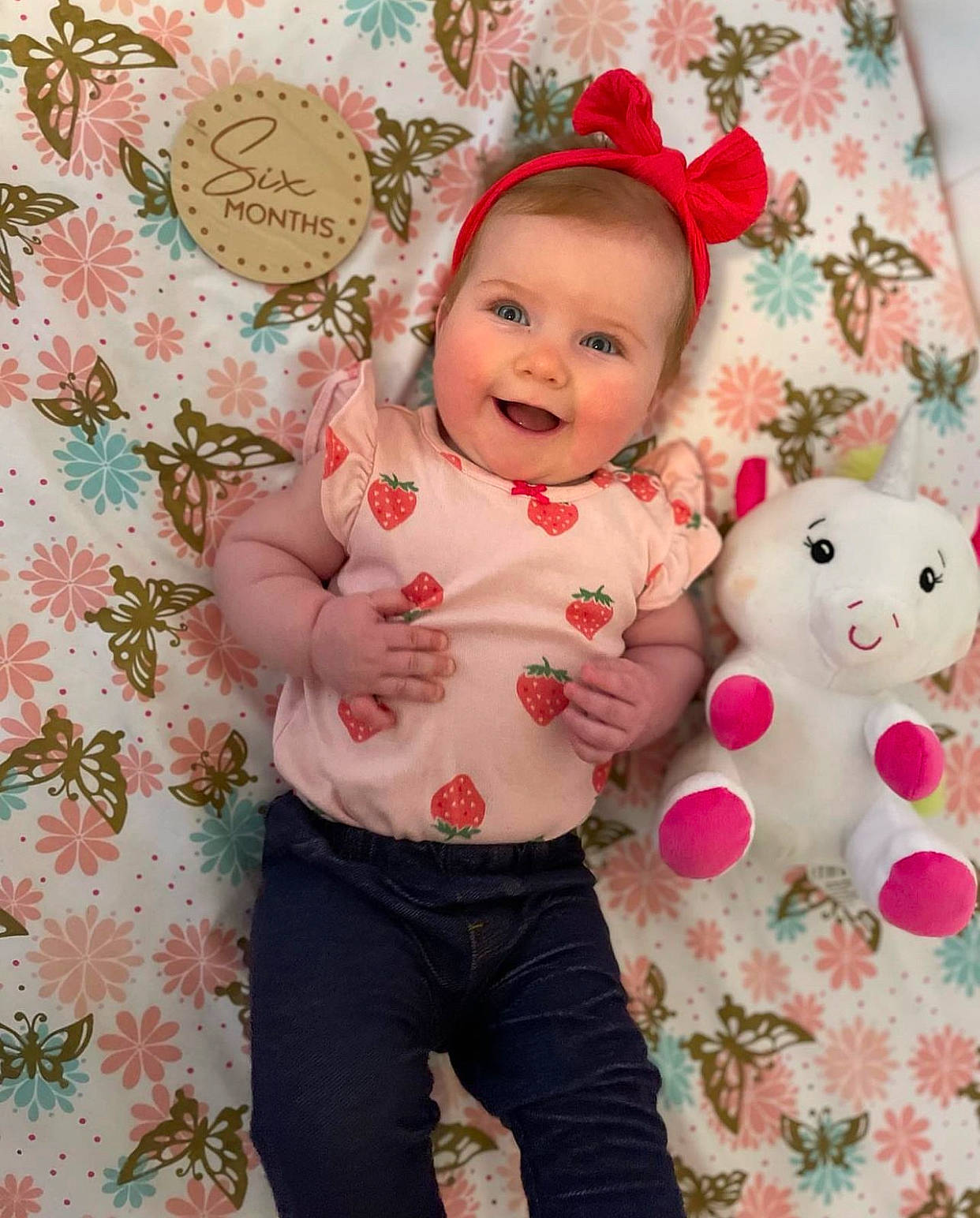 Madison is registered to the contest to win money with this photo: baby, baby_toddler_clothing, cheek, child, happy, holiday, joy, linens, magenta, pattern, peach, people_in_nature, person, pink, product, skin, sleeve, smile, teddy_bear, toddler