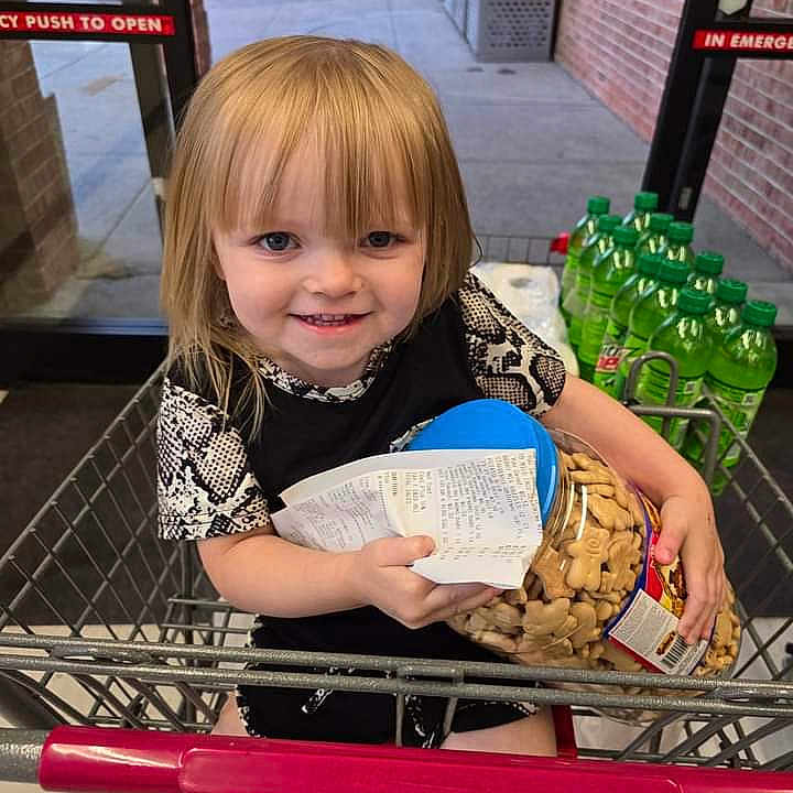 Valhela Storm joined the competition — help win amazing prizes! aisle, animal_crackers, blonde_hair, child, clothing, drink_bottles, face, floor, grocery, happy, holding, indoor, person, plastic_container, receipt, retail, shopping_cart, shorts, smiling, store