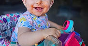 Ellamae is registered to the contest to win money with this photo: baby, child, messy_face, smiling, walker, toy, indoor, playful, happy, young_child, colorful, clothing, seat, person, portrait, cute, fun, early_childhood, infant, expression