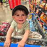 baby, child, shopping_cart, grocery_store, snacks, chips, coca_cola, smiling, cap, blanket, aisle, person, retail, happy, cute, infant, clothing, store, hands, floor