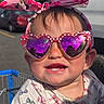 toddler, child, sunglasses, heart_shaped, purple_lenses, headband, minnie_mouse, pink, shopping_cart, outdoor, sunlight, smile, teeth, clothing, pattern, bows, cute, happy, portrait, baby