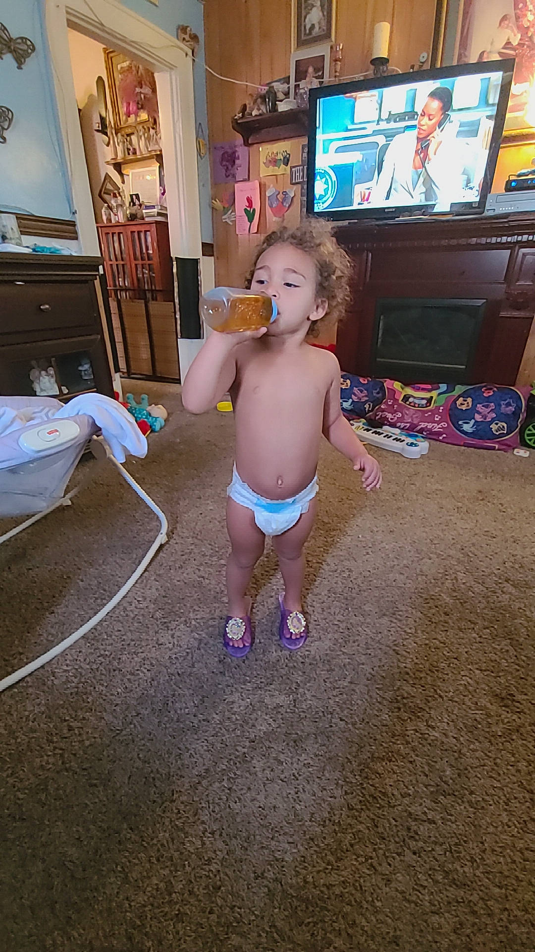 Kaylyn joined the competition — help win amazing prizes! baby, cable_television, couch, diaper, electronic_device, entertainment_center, finger, floor, flooring, fun, hardwood, human_leg, living_room, person, picture_frame, television, television_set, thigh, toddler, trunk