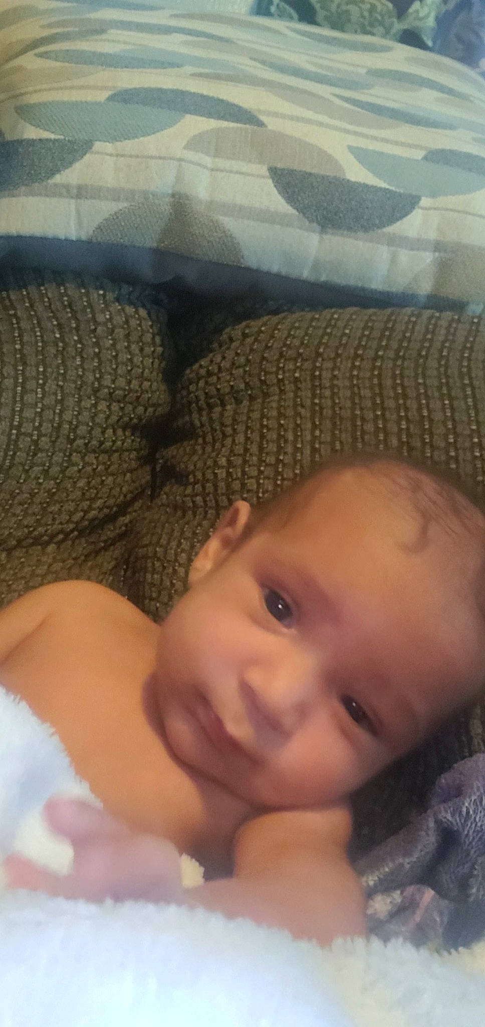 Jaden is registered to the contest to win money with this photo: baby, cheek, chin, comfort, eye, eyebrow, eyelash, face, finger, forehead, hand, head, iris, lip, mouth, nose, organ, person, skin, smile