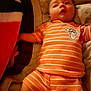 Levi joined the competition — help win amazing prizes! baby, infant, orange_striped_clothing, lying_down, blanket, soft_fabric, bed, child, cute, portrait, sleepwear, pajamas, indoors, young_child, face, arms, legs, comfort, relax, expression