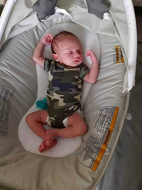 Juan is registered to the contest to win money with this photo: baby, baby_carriage, baby_products, baby_toddler_clothing, child, comfort, elbow, finger, gesture, human_body, infant_bed, pattern, person, product, sitting, sleeve, sock, textile, thumb, toddler