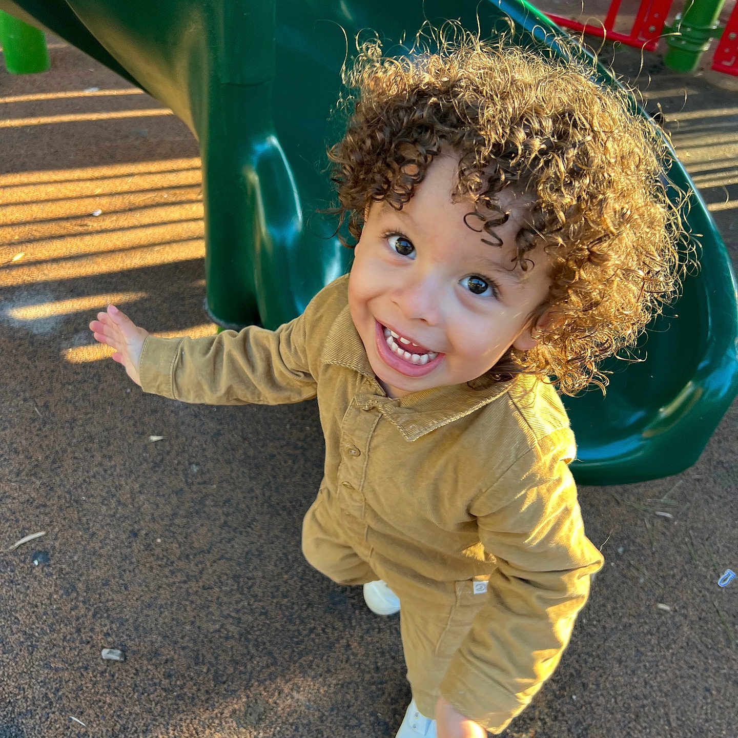 Sylas is registered to the contest to win money with this photo: bodypart, child, clothing, face, female, finger, footwear, girl, grass, head, outdoorplayarea, outdoors, person, photography, plant, playarea, portrait, shoe, slide, toy