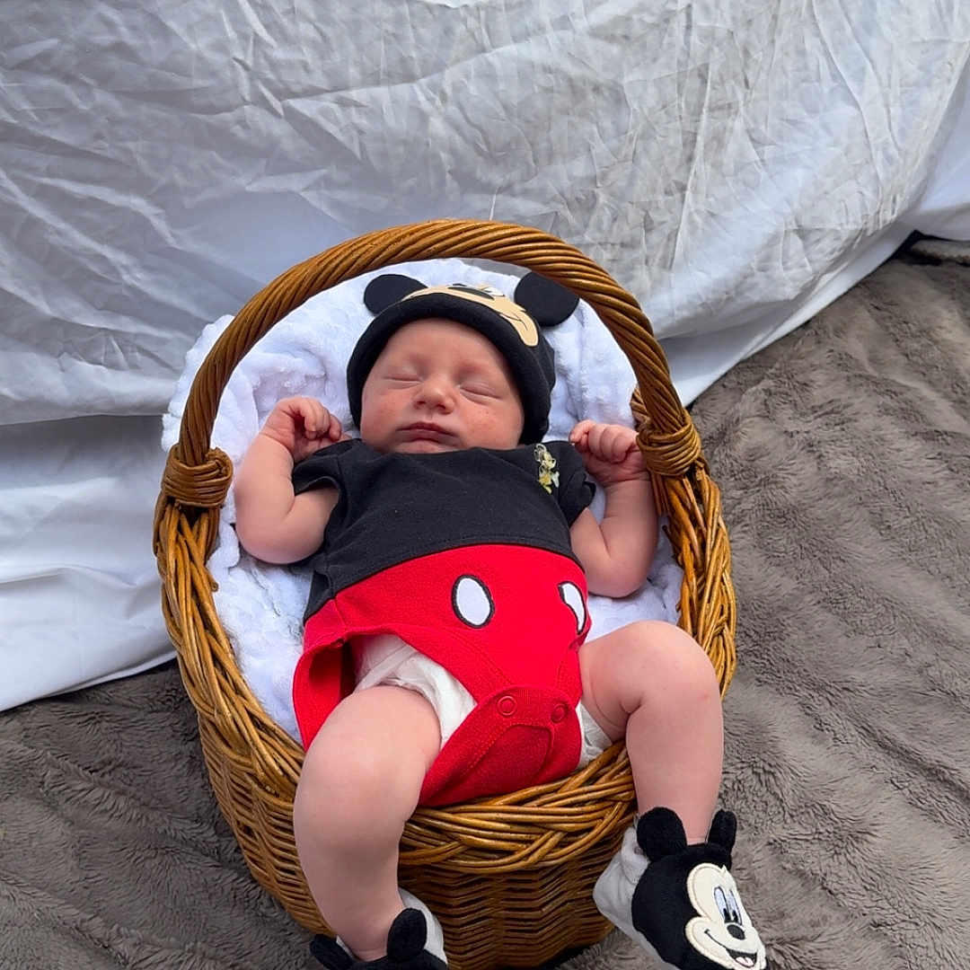 Eden participe au concours pour gagner de l'argent avec cette photo : baby, basket, blanket, booties, child, clothing, cute, diaper, fur_rug, hat, indoor, infant, mickey_mouse, newborn, person, resting, sleeping, soft_texture, white_background, wicker