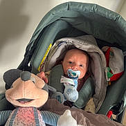 Eden participe au concours pour gagner de l'argent avec cette photo : baby, blanket, child, clothing, comfort, cute, face, head, indoor, infant, mickey_mouse, pacifier, person, plush_toy, rest, seated, soft_toy, stroller, toy, young_child