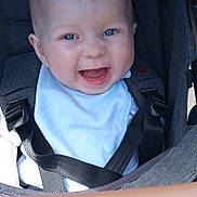 Oliver is registered to the contest to win money with this photo: baby, smiling, blue_eyes, stroller, car_seat, straps, infant, happy, child, clothing, face, seatbelt, cute, portrait, baby_bib, safety, closeup, skin, head, expression