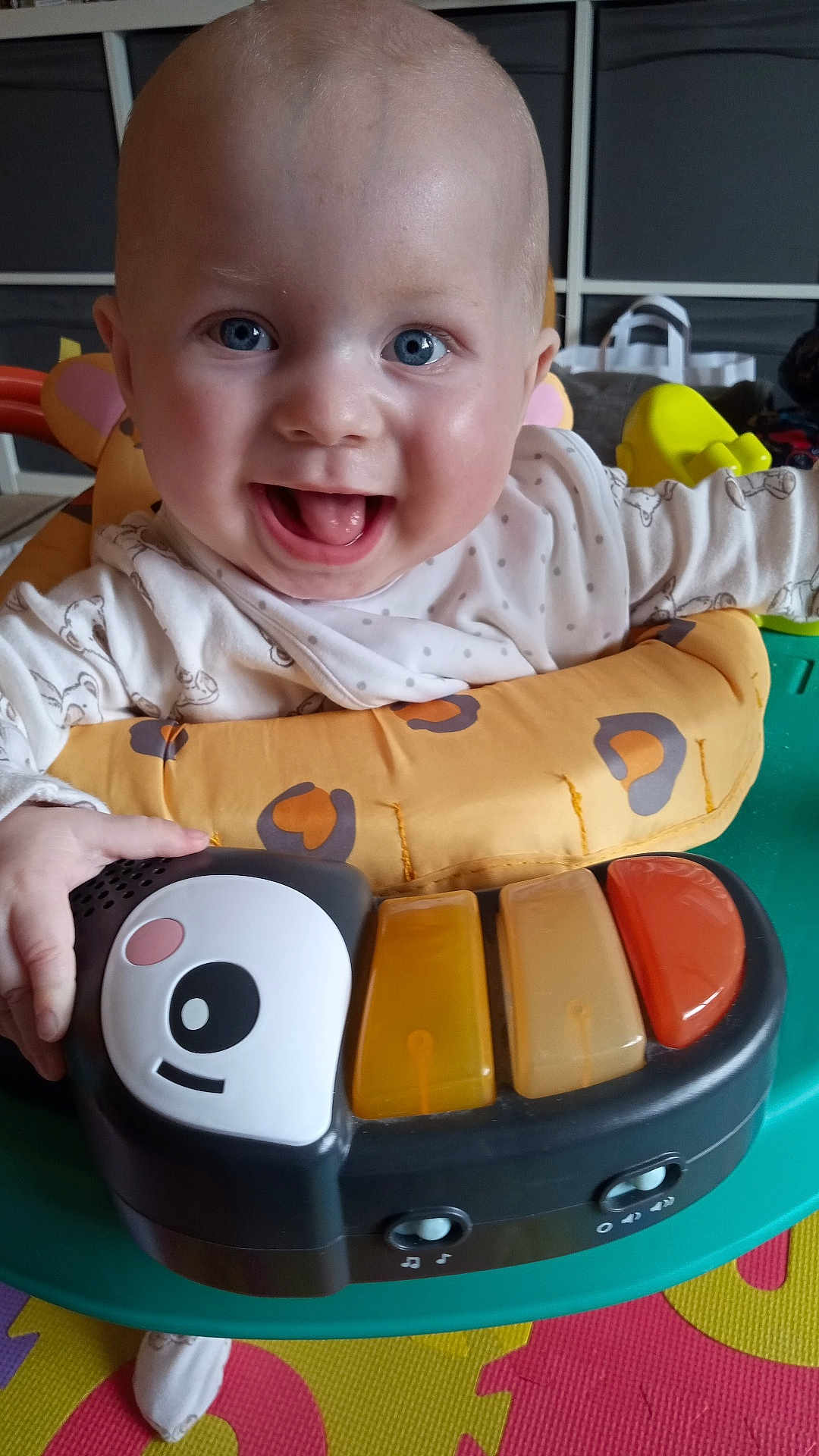 Oliver joined the competition — help win amazing prizes! baby, child, smiling, toy, piano, play_area, blue_eyes, joyful, indoor, colorful, plastic, clothing, seat, hand, face, expression, infant, happy, playtime, fun