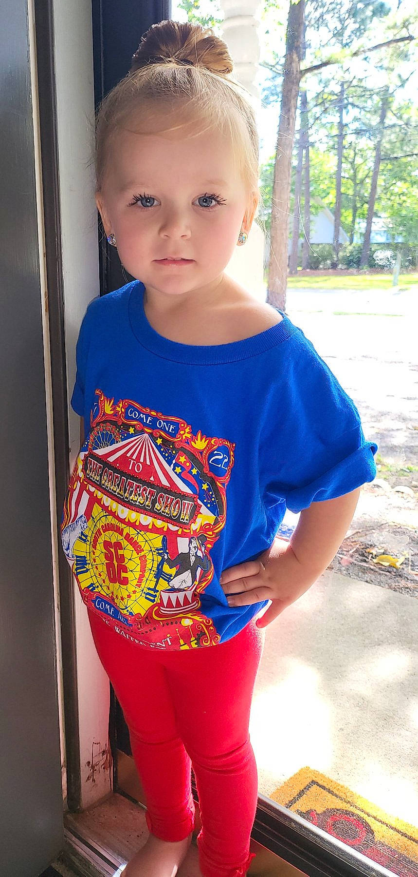 Parker is registered to the contest to win money with this photo: active_shirt, baby_toddler_clothing, child, cool, electric_blue, fashion_design, happy, neck, outerwear, pattern, person, plant, sleeve, sportswear, standing, t_shirt, textile, thigh, toddler, tree