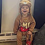Henry joined the competition — help win amazing prizes! toddler, child, hat, slippers, brown_clothing, indoor, window, smiling, sitting, car_character, cozy, floor, carpet, radiator, curtains, cute, face, happy, person, toy_theme