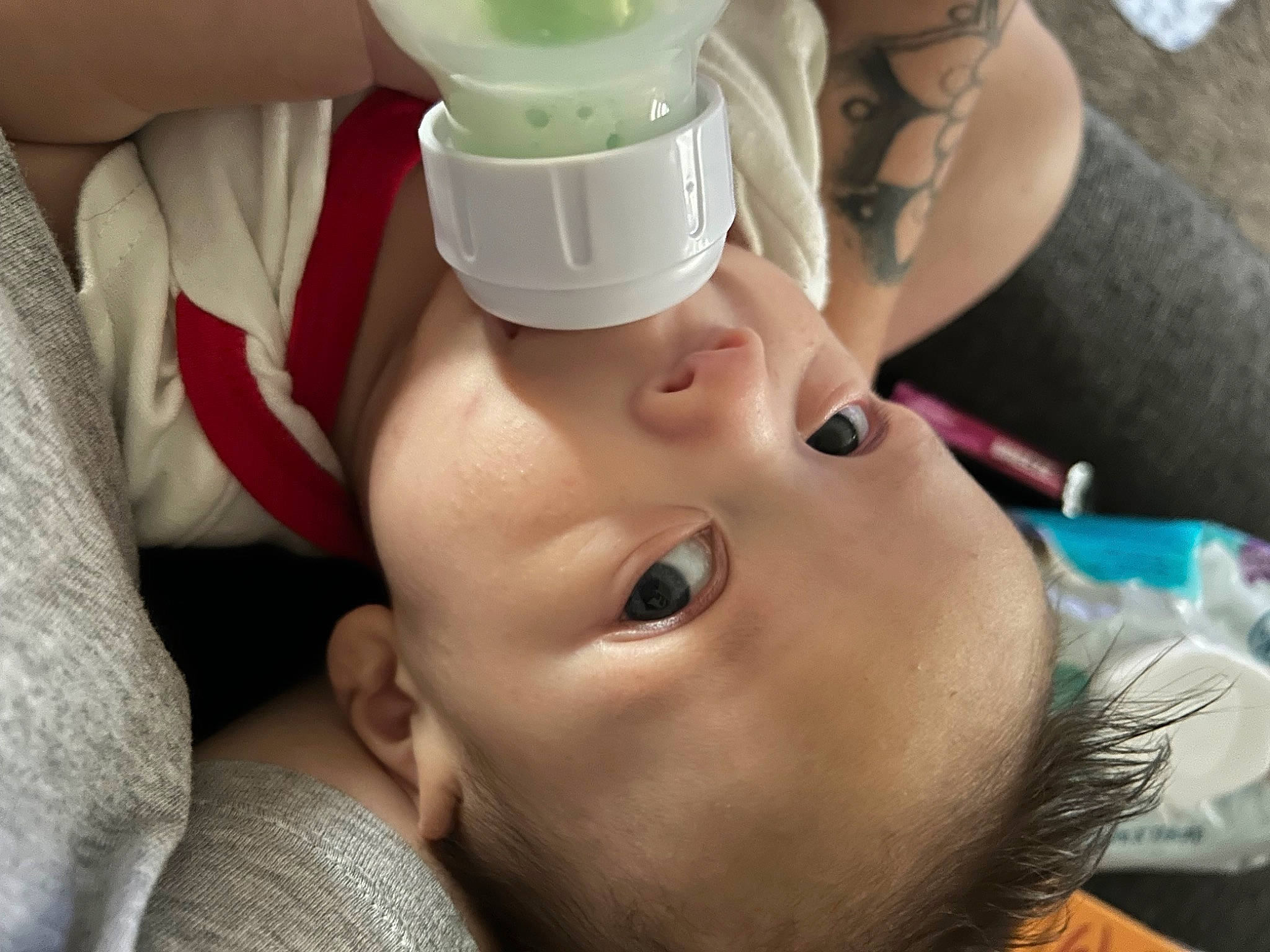 Marcellus is registered to the contest to win money with this photo: baby, bathing, cheek, child, drinkware, eye, eyelash, face, finger, fun, gesture, happy, mouth, nail, nose, person, personal_protective_equipment, service, skin, thumb