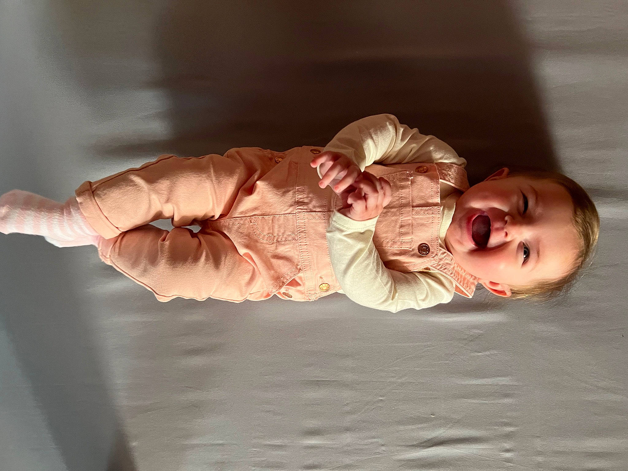 Emmy is registered to the contest to win money with this photo: baby, baby_toddler_clothing, cheek, child, comfort, ear, finger, flash_photography, fun, gesture, hand, happy, human_body, neck, person, sitting, sleeve, smile, thumb, toddler