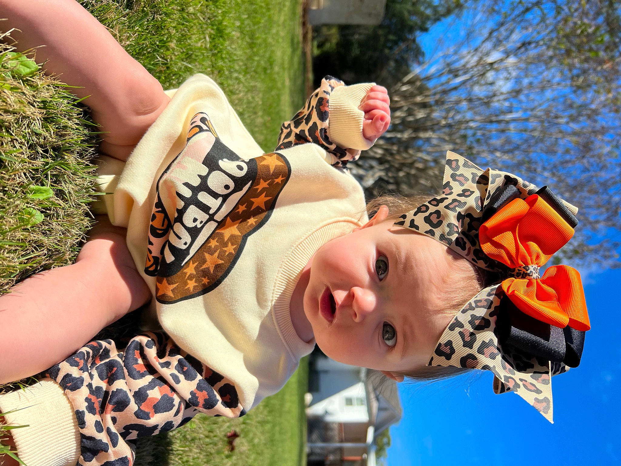 Emmy is registered to the contest to win money with this photo: baby, child, eyewear, fun, grass, happy, hat, human_leg, leisure, pattern, people_in_nature, person, personal_protective_equipment, plant, play, recreation, smile, sunglasses, thigh, toddler