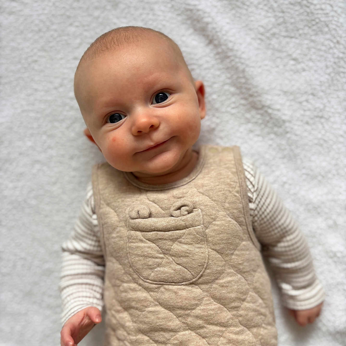 Evan joined the competition — help win amazing prizes! baby, blanket, bodypart, clothing, face, finger, hand, happy, head, knitwear, longsleeve, newborn, pants, person, photography, portrait, quilt, sleeve, smile, sweater