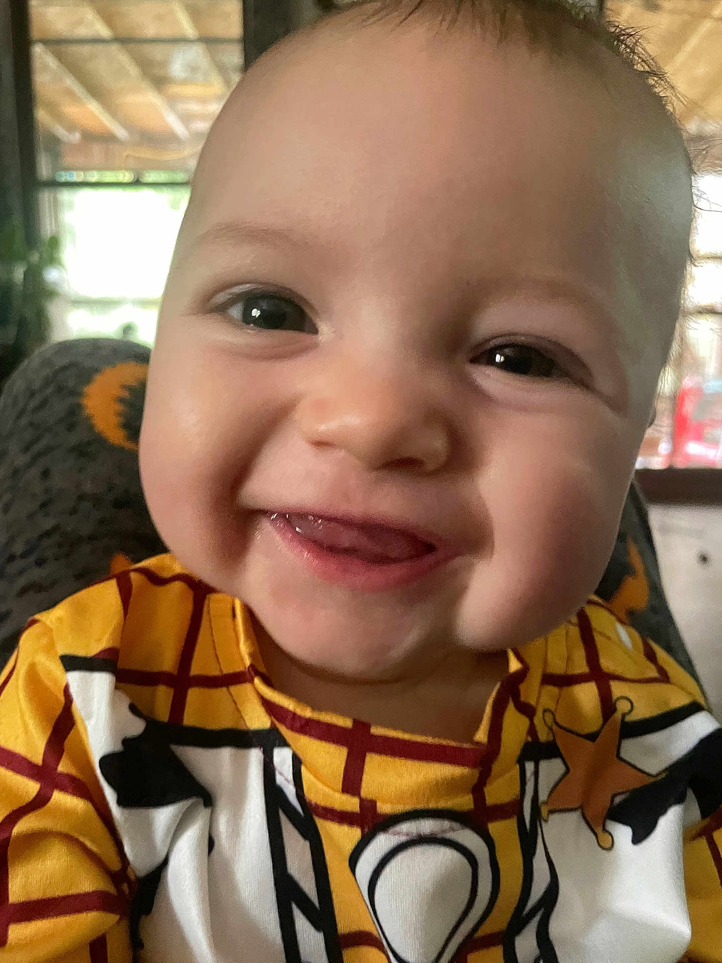 Shawn joined the competition — help win amazing prizes! baby, child, smile, face, tongue, clothing, indoor, joyful, close_up, person, cute, young, infant, patterned_shirt, happy, portrait, head, eyes, skin, expression