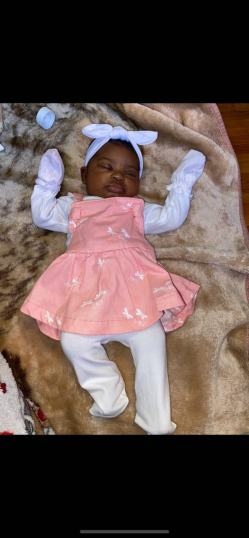 Aubrielle is registered to the contest to win money with this photo: baby, baby_toddler_clothing, child, comfort, dress, fashion_accessory, finger, fun, happy, human_leg, linens, magenta, pattern, person, pink, play, recreation, sitting, sleeve, thigh