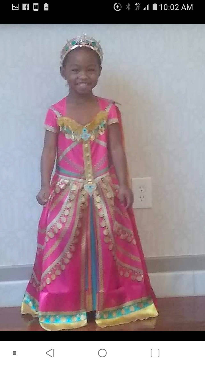 K Monroe is registered to the contest to win money with this photo: day_dress, dress, embellishment, event, fashion_accessory, fashion_design, formal_wear, happy, headpiece, jewellery, joy, magenta, necklace, one_piece_garment, pattern, person, pink, sleeve, smile, tradition