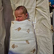 Jake joined the competition — help win amazing prizes! newborn, baby, swaddled, blanket, sleeping, infant, bed, cozy, cute, soft, paw_prints, peaceful, wrapped, child, indoors, resting, portrait, head, face, toddler