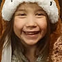 child, smile, hat, animal_hat, fluffy, brown, white, face, happy, indoors, clothing, cute, portrait, young, person, long_hair, warm, fun, joy, headwear