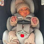 Luciana joined the competition — help win amazing prizes! baby, car_seat, knit_hat, knit_booties, knit_sweater, infant, child, seat_belt, car_interior, cute, warm_clothing, pom_pom, newborn, portrait, sitting, childrens_fashion, safety, indoors, person, young_child