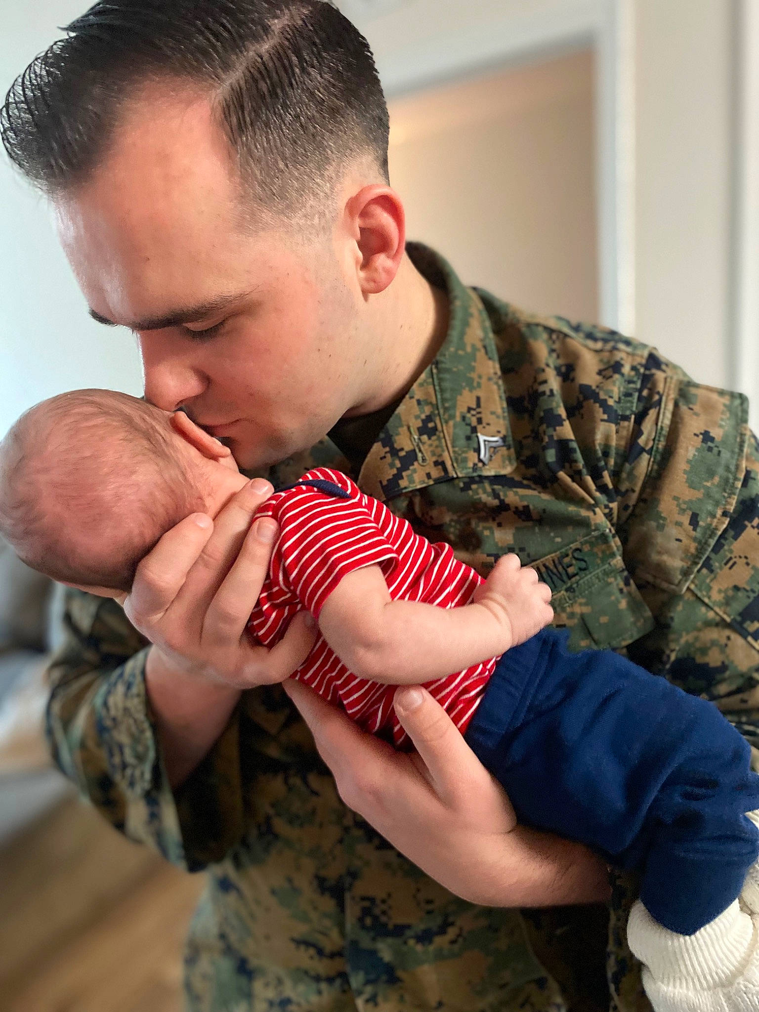 Colter is registered to the contest to win money with this photo: arm, army, camouflage, comfort, elbow, finger, gesture, hand, happy, human_body, interaction, joint, military_camouflage, muscle, neck, person, shoulder, skin, sleeve, soldier