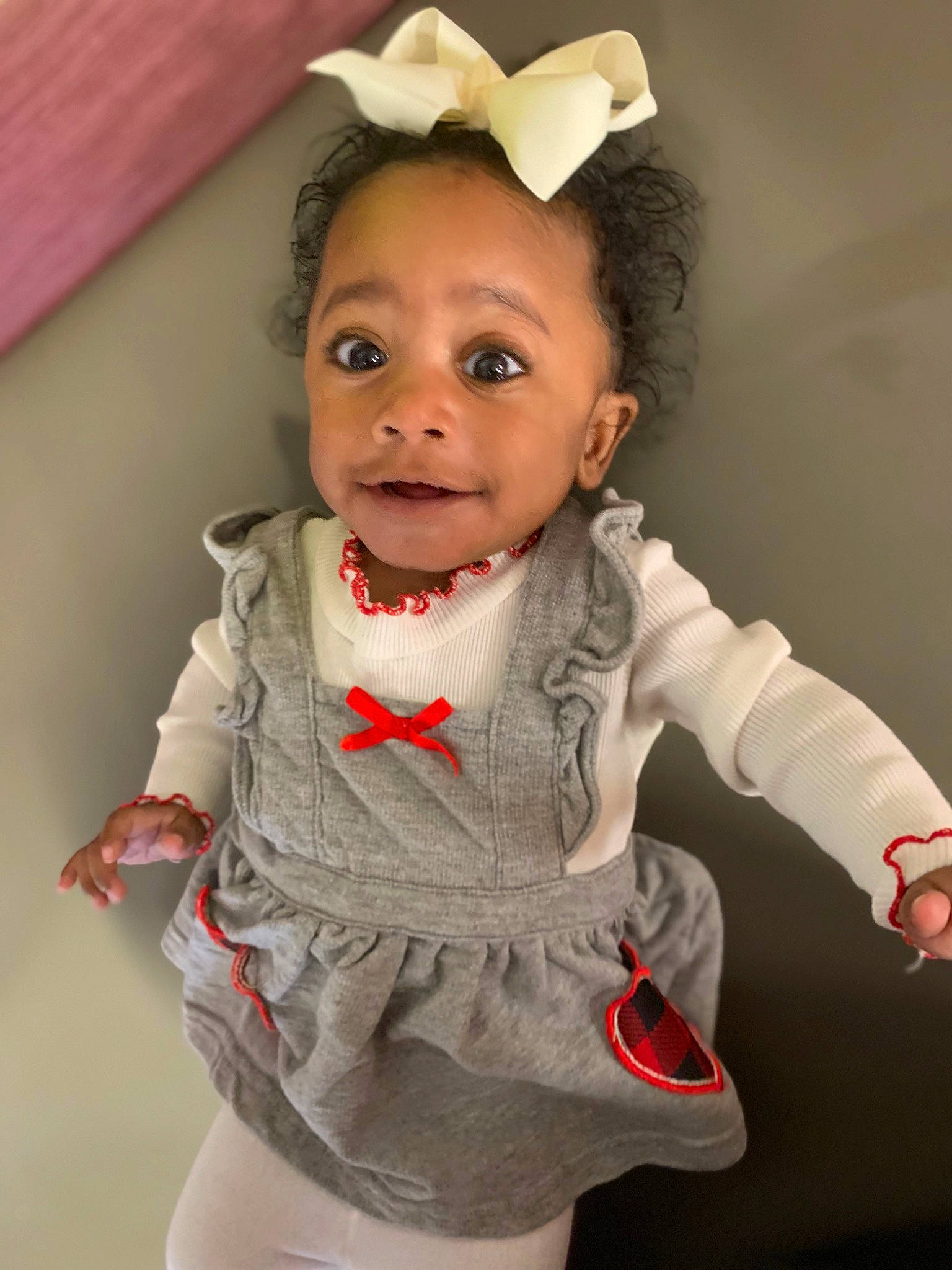 Sanai is registered to the contest to win money with this photo: baby_toddler_clothing, dress, ear, eye, eyebrow, eyelash, face, gesture, hair, happy, head, human_body, iris, lip, neck, outerwear, person, pink, skin, sleeve