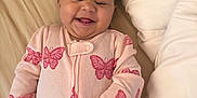 Kristiahnna joined the competition — help win amazing prizes! baby, bed, blanket, butterfly_pattern, child, cozy, cute, face, hand, happy, indoor, infant, lying_down, person, pink_outfit, skin, sleepwear, smiling, soft_lighting, toy