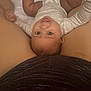 Kristiahnna is registered to the contest to win money with this photo: baby, infant, smiling, bed, adult, legs, clothing, skin, lying_down, happy, portrait, indoor, person, closeup, cute, human, child, white_bed, casual, expression