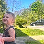 Luca joined the competition — help win amazing prizes! child, toddler, smiling, outdoor, green_shorts, sleeveless_shirt, grass, tree, bush, sidewalk, car, sunny, blue_sky, happy, nature, road, daytime, person, casual_clothing, young_child