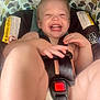 toddler, child, car_seat, seat_belt, smiling, laughing, happy, baby, safety, indoor, cute, legs, hands, patterned, fabric, playful, young_child, closeup, infant, person