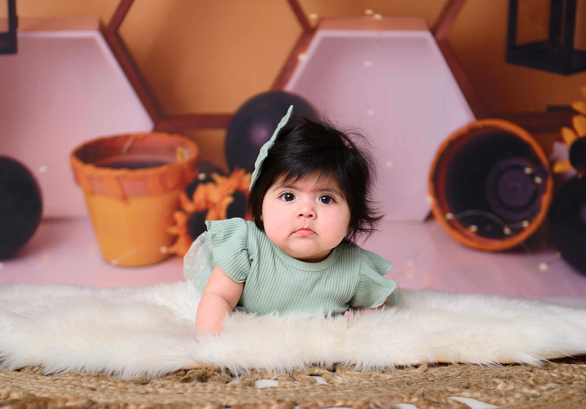 Violette is registered to the contest to win money with this photo: baby, infant, child, face, curious, hair_bow, fluffy_rug, soft_lighting, indoor, decor, balloons, portrait, cute, crawling, green_dress, young_child, closeup, expression, floor, background