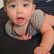 Ryan joined the competition — help win amazing prizes! baby, child, infant, portrait, face, eyes, wide_eyes, open_mouth, surprised, smiling, lying_down, bed, bedroom, indoor, striped_clothing, brown_hair, hand, adult_hand, parent, close_up