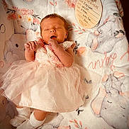 Ivy is registered to the contest to win money with this photo: baby, bed, blanket, clothing, crib, face, furniture, happy, head, infantbed, newborn, person, photography, portrait, sitting, sleeve, yawning