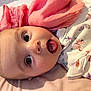 Mya joined the competition — help win amazing prizes! baby, infant, face, tongue, blanket, pink, butterfly_pattern, clothing, laying_down, cute, child, soft_texture, closeup, portrait, happy, skin, head, eyes, expression, indoors