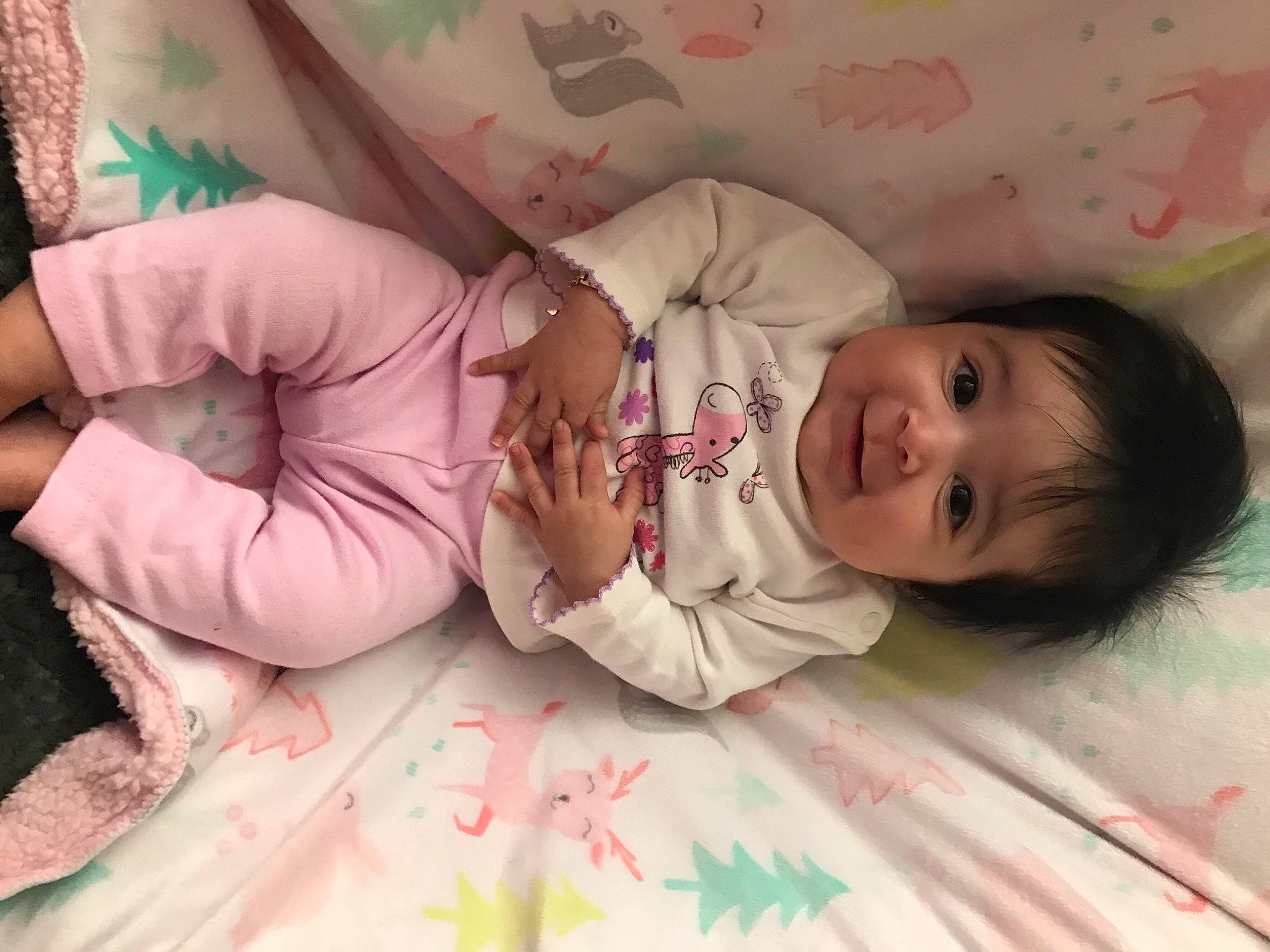 Analía is registered to the contest to win money with this photo: baby, baby_toddler_clothing, bed, bedding, cheek, comfort, dress, facial_expression, finger, hand, head, headgear, linens, mammal, people, person, pink, skin, sleeve, smile