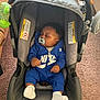 baby, infant, sleeping, pacifier, car_seat, blue_clothing, socks, toy, indoor, carpet, child, person, couch, blanket, comfort, rest, hood, infant_clothing, cozy, relaxation