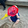 toddler, child, sand, playground, toy, plastic, sieve, shovel, blue_clothing, barefoot, adult, bench, wood, outdoor, play, fun, legs, person, sitting, fence